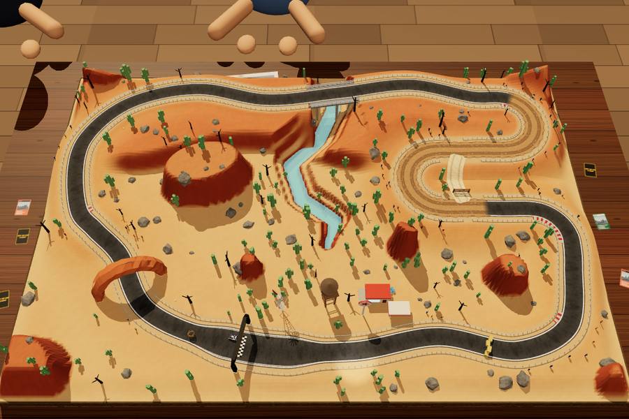 A desert diorama with red rock, cactus and a river canyon